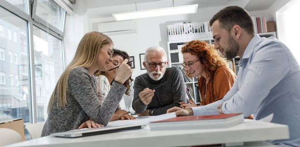 istock Working day in a design studio. Group of designers and architects on meeting. 1426193760