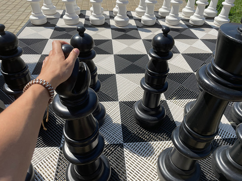 Outdoor oversized chess public area zone, Selective focus of big pieces of street chess in the park, Hobby, Leisure and activities