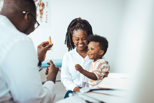 istock Attentive male doctor support cheer little kid patient. 1426197927
