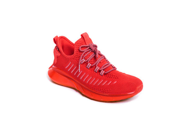 istock red sneaker on a teenager on a white isolated background. 1426201400