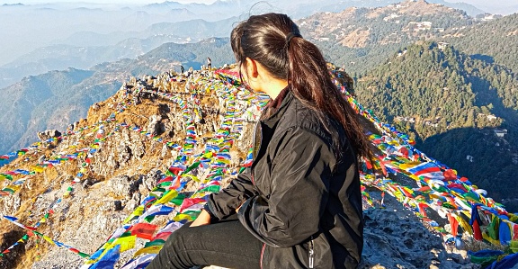 Mussoorie, India- September 22,2022: Rear View of a Young Women Looking At Mountains while Sitting At the Peak Of George Everest, Mussoorie.