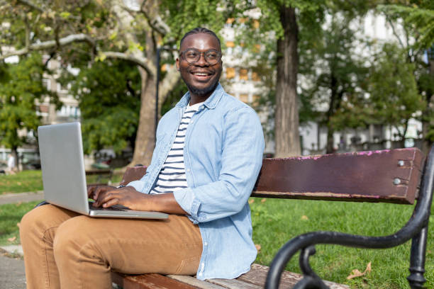 istock Smart male student studying in a park during a sunny afternoon 1426204157