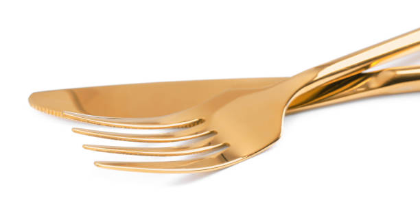 istock Golden fork and knife on white background 1426209523