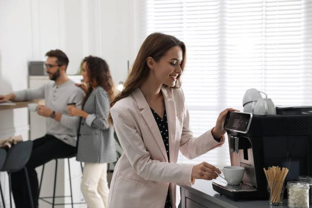 istock Woman preparing fresh aromatic coffee with modern machine in office 1426212387
