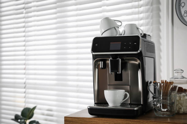 Modern coffee machine with cup in office. Space for text Modern coffee machine with cup in office. Space for text coffee maker stock pictures, royalty-free photos & images