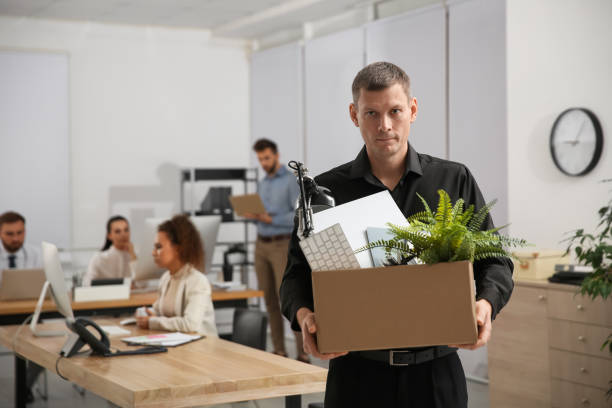 istock Upset dismissed man carrying box with stuff in office, space for text 1426212927