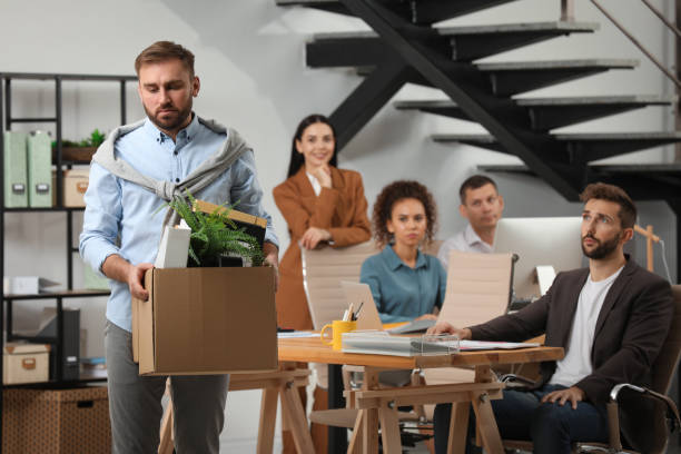 istock Upset dismissed man carrying box with stuff in office, space for text 1426213132