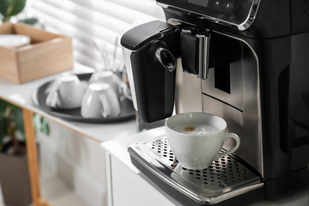 istock Modern coffee machine with cup of cappuccino in office. Space for text 1426213482