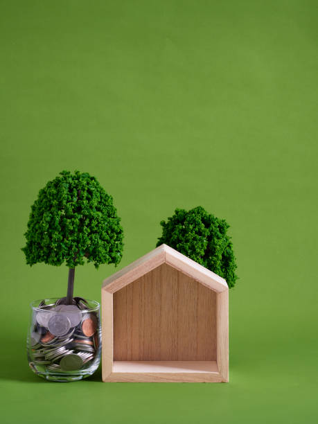 istock Miniature houses with coins stacks. Mortgage concept 1426214471