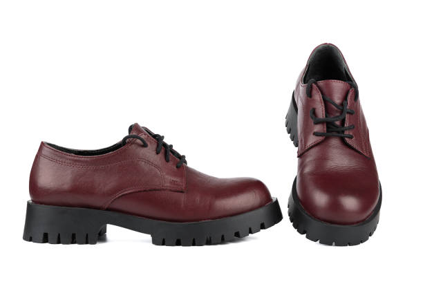 istock Pair of women's lace-up brogue boots with thick soles. 1426215122