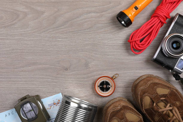 istock Flat lay composition with different camping equipment on wooden background, space for text 1426216068