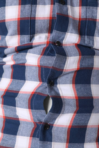 istock Man wearing tight shirt, closeup view. Overweight problem 1426216646