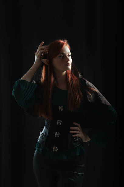 Beautiful redhead elf girl on black background