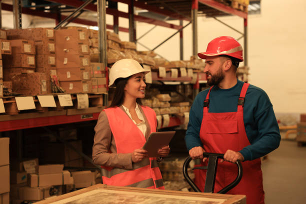 istock Manager and worker at warehouse. Logistics center 1426218208