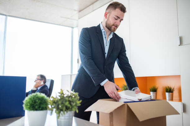 istock Young Businessman Organizing Some Documents On His Office Desk 1426220862