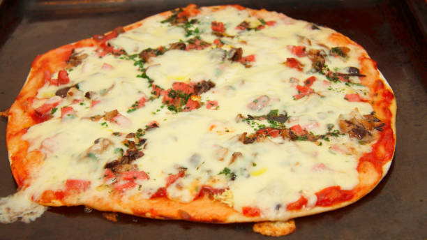 istock Pizza with mozzarella, fried mushrooms, sausage and parsley 1426221636