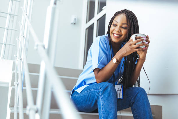 istock Female doctor sitting with mobile phone and drinking coffee. 1426223277