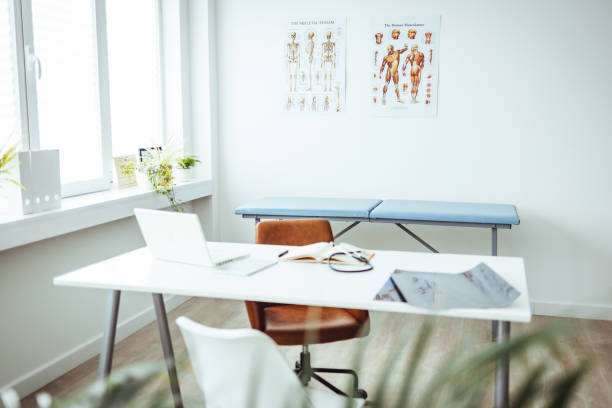 istock Interior of empty pediatrician office with bed and computer. 1426223530