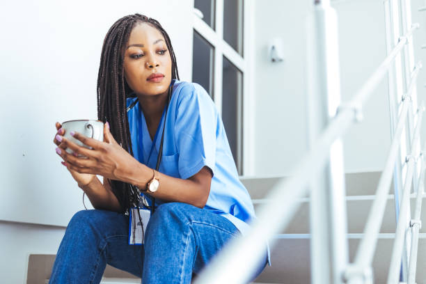 istock Female doctor sitting with mobile phone and drinking coffee 1426224394