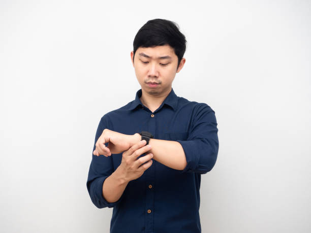 istock Asian man gesture looking at his watch serious emotion white background 1426224496