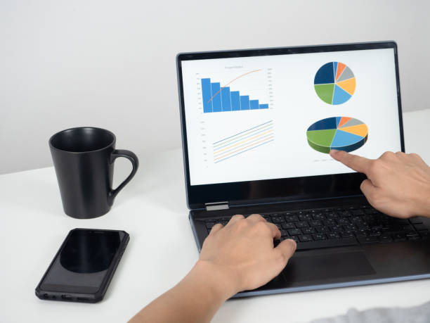 istock Man hand  working with laptop on the desk with mobile phone and coffee cup 1426226762