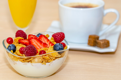 bowl with banana, blueberry, granola, oat, kiwi and coffee