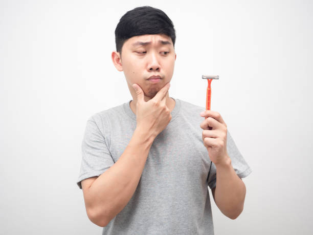 istock Man touch feeling doubt and looking at shaving in hand 1426227174