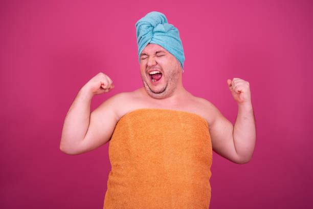 istock Funny fat man is washing himself in the shower. 1426227408