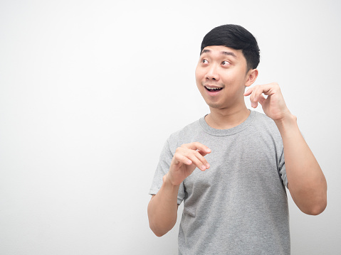 Asian man gesture dancing funny and looking at copy space