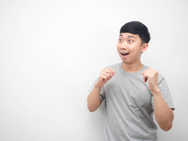 istock Man gesture dancing funny and looking at copy space 1426227529