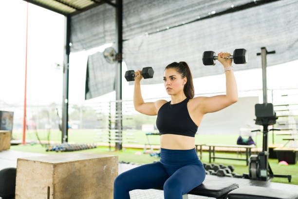 istock Active young woman working out with dumbbell weights 1426229264
