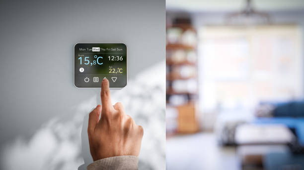 istock Setting room temperature on wall thermostat - Low winter temperatures in homes caused by the energy crisis in Europe 1426231799
