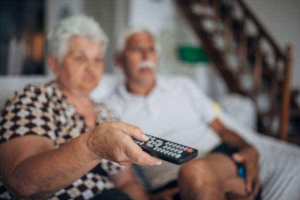 istock Senior couple watching tv at home 1426232313