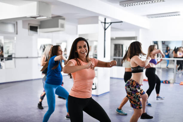 istock Female Smiling During Zumba Dance Class Moves 1426235413
