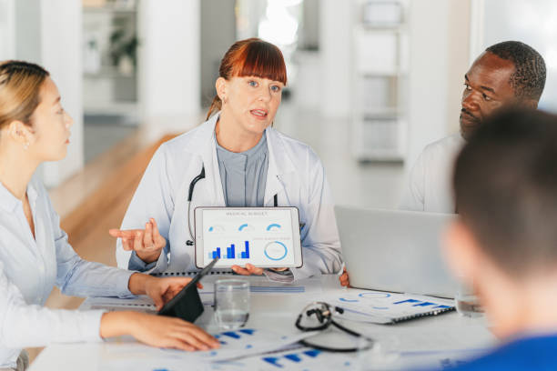 Medicine, data and doctors in meeting with charts or graphs on medical statistics, strategy and reports. Teamwork, planning and coaching, women and men in healthcare working together for good results medicina, datos y médicos en reunión con tablas o gráficos sobre estadísticas médicas, estrategia e informes. trabajo en equipo, planificación y coaching, mujeres y hombres en el cuidado de la salud trabajando juntos para obtener buenos resultados