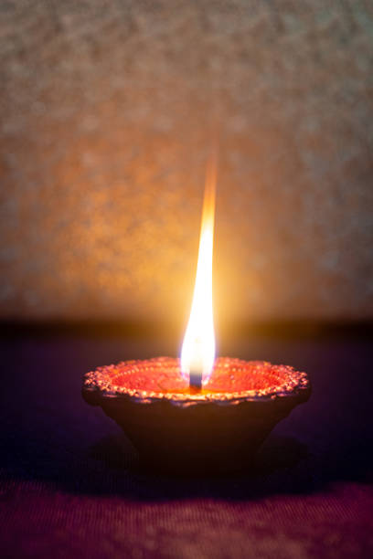 istock Happy Diwali - Clay diya lamp lit during diwali celebration 1426236405