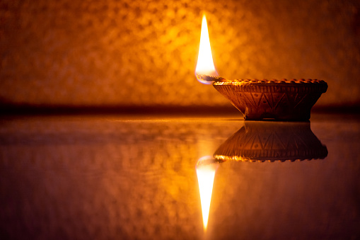 Happy Diwali - Clay diya lamp lit during diwali celebration
