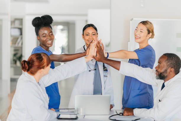 istock Team high five, doctors and nurses in celebration, teamwork and partnership. Success, trust and health with medical professionals working together in unity, union and solidarity at hospital. 1426236499