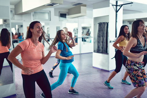 Females Feeling Song Rhythm In Gym And Enjoying Zumba Class