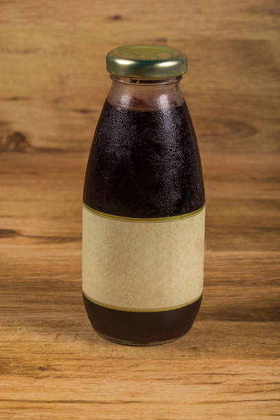 Grape Juice Bottle on Wooden Background  Mock-Up .