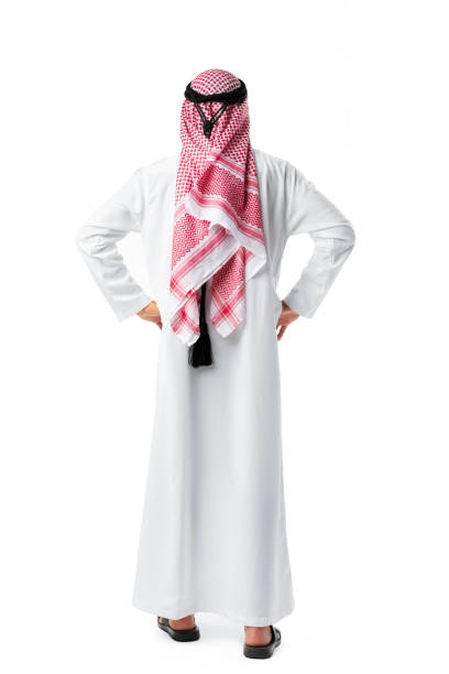 istock Back view of an Arab man standing on white isolated background 1426237096