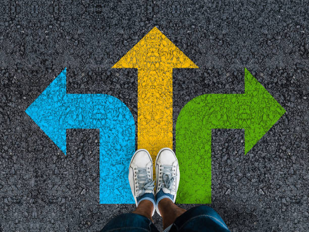 istock man legs on road with three direction arrow choices 1426239391