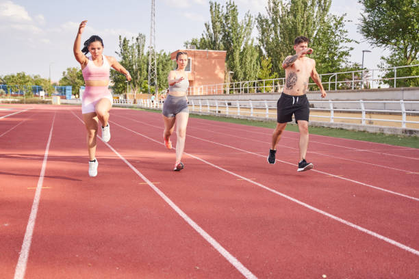 istock group of people training on the athletics track 1426239717
