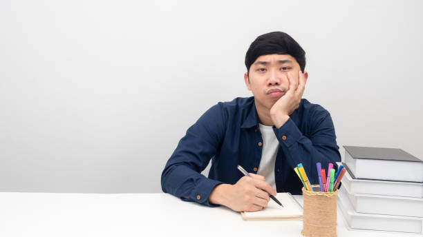 istock Man sitting at workplace desk gesture bored to working 1426242055
