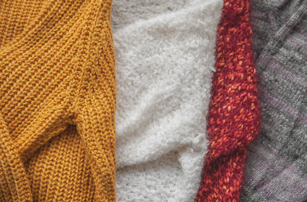 istock Autumn and winter background with knitted colourful sweaters 1426242571