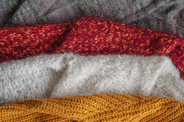 istock Autumn and winter background with knitted colourful sweaters 1426245742
