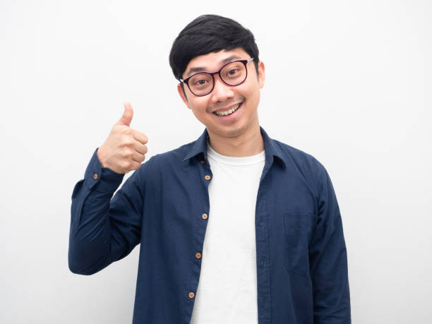 istock Handsome man wearing glasses gesture thumb up happy smile white background 1426245845