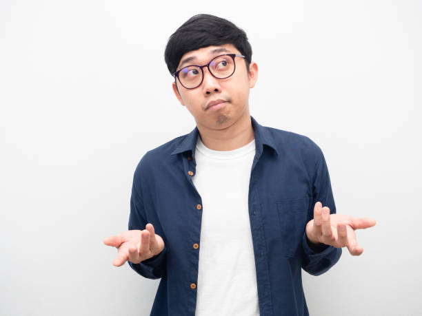 istock Man wearing glasses feeling bored shrug shoulder white background 1426245883