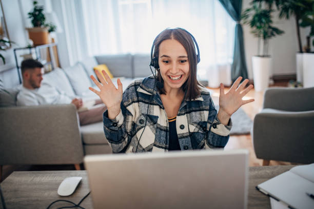 istock Young woman working from home while her boyfriend using smart phone next to her 1426245916