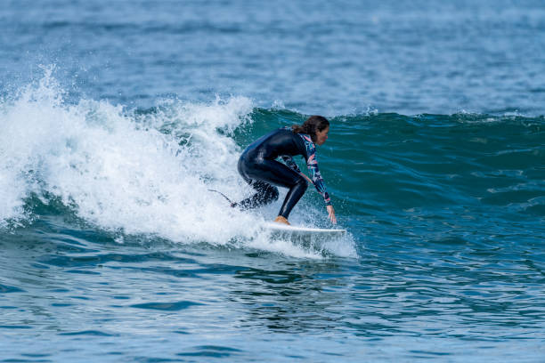 istock Surfer girl riding a wave 1426247989